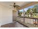 Screened balcony with ceiling fan, access door, and view of parking lot at 1600 Big Tree Rd # B5, South Daytona, FL 32119