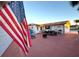 Spacious backyard patio with outdoor dining area and an American flag at 21 Sunset Blvd, Ormond Beach, FL 32176