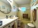 Clean bathroom with a yellow bathtub, sink, and toilet at 21 Sunset Blvd, Ormond Beach, FL 32176