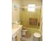 Bathroom with yellow-tiled shower and white vanity at 21 Sunset Blvd, Ormond Beach, FL 32176