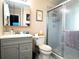 Bathroom with gray vanity, shower, and toilet at 21 Sunset Blvd, Ormond Beach, FL 32176