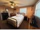 Cozy bedroom with a metal-framed bed, dresser, and TV at 21 Sunset Blvd, Ormond Beach, FL 32176