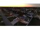 Aerial view of a residential neighborhood at sunset with a coastal backdrop at 21 Sunset Blvd, Ormond Beach, FL 32176