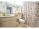 Clean bathroom with seashell shower curtain and updated vanity at 2294 Ocean Shore Blvd # 1020, Ormond Beach, FL 32176