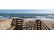 Wooden staircase leads to sandy beach at 2294 Ocean Shore Blvd # 1020, Ormond Beach, FL 32176