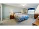 Comfortable bedroom with a quilt bedspread and wooden furniture at 2294 Ocean Shore Blvd # 1020, Ormond Beach, FL 32176