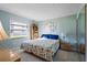 Bright bedroom with a floral comforter and plenty of natural light at 2294 Ocean Shore Blvd # 1020, Ormond Beach, FL 32176