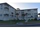 View of beachfront condo building with palm trees and a community pool at 2294 Ocean Shore Blvd # 1020, Ormond Beach, FL 32176