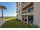 Oceanfront condo building with grassy area and patio at 2294 Ocean Shore Blvd # 1020, Ormond Beach, FL 32176