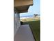 Concrete walkway leading towards the ocean, with grass alongside at 2294 Ocean Shore Blvd # 1020, Ormond Beach, FL 32176