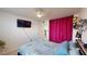 Another view of the second bedroom showcasing the pink curtains and decor at 2727 N Atlantic Ave # 203, Daytona Beach, FL 32118