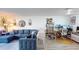 Living room with blue sectional sofa, workspace area, and holiday decor at 2727 N Atlantic Ave # 203, Daytona Beach, FL 32118