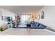 Living room with a sectional sofa, a Christmas tree, and a TV at 2727 N Atlantic Ave # 203, Daytona Beach, FL 32118