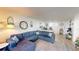 Open-concept living room with blue sectional and holiday decorations at 2727 N Atlantic Ave # 203, Daytona Beach, FL 32118