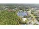 High-angle view of a house with a lake view and surrounding trees at 3 Marsh Ridge Watch, Ormond Beach, FL 32174