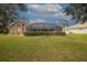 Expansive backyard featuring a screened porch and well-maintained lawn at 3 Marsh Ridge Watch, Ormond Beach, FL 32174