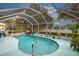 Screened-in pool with seating area, overlooking lake at 3 Marsh Ridge Watch, Ormond Beach, FL 32174