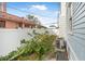 Side yard with a white fence, small garden area, and AC unit at 318 Vermont Ave, Daytona Beach, FL 32118