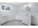 Bathroom with white vanity, circular mirror, and black and white checkered floor at 318 Vermont Ave, Daytona Beach, FL 32118