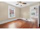 Bedroom with polished wood floors, ceiling fan, and adjacent room at 318 Vermont Ave, Daytona Beach, FL 32118