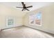 Carpeted bedroom with ceiling fan and windows overlooking rooftops at 318 Vermont Ave, Daytona Beach, FL 32118