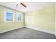 Bedroom with gray carpet, light green walls, and two windows at 318 Vermont Ave, Daytona Beach, FL 32118