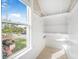 Walk-in closet with built-in shelves and window with neighborhood view at 318 Vermont Ave, Daytona Beach, FL 32118