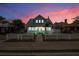 Charming light blue beach house at twilight with white picket fence at 318 Vermont Ave, Daytona Beach, FL 32118