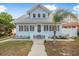Front view of a charming light blue beach house with a walkway leading to the entrance at 318 Vermont Ave, Daytona Beach, FL 32118