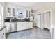 Bright kitchen featuring white cabinets, dark granite countertops, and stainless steel appliances at 318 Vermont Ave, Daytona Beach, FL 32118