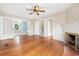 Living room with hardwood floors, fireplace, and ceiling fan at 318 Vermont Ave, Daytona Beach, FL 32118