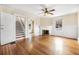 Living room featuring hardwood floors, a fireplace with a white mantel, and white wainscoting at 318 Vermont Ave, Daytona Beach, FL 32118