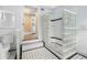 Glass block shower with white tile and checkered floor at 318 Vermont Ave, Daytona Beach, FL 32118