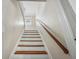 Staircase with wooden handrail and white risers at 318 Vermont Ave, Daytona Beach, FL 32118