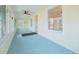 Sunroom with light blue flooring, ceiling fan, and windows offering views of the neighborhood at 318 Vermont Ave, Daytona Beach, FL 32118