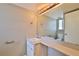 Simple bathroom with a single vanity, toilet, and large mirror at 3522 Forest Branch Dr # D, Port Orange, FL 32129