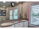 Elegant bathroom with double sinks, a large mirror, and plantation shutters at 546 Rio Vista Ave, Daytona Beach, FL 32114