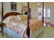 Spacious bedroom featuring a four-poster bed, floral bedding, and ensuite bathroom access at 546 Rio Vista Ave, Daytona Beach, FL 32114
