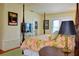 Inviting bedroom with a four-poster bed, floral bedding, and a TV at 546 Rio Vista Ave, Daytona Beach, FL 32114