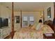 Bedroom with four-poster bed, floral bedding, and windows overlooking water at 546 Rio Vista Ave, Daytona Beach, FL 32114