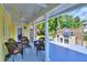 Relaxing covered patio with outdoor furniture and built-in grill at 546 Rio Vista Ave, Daytona Beach, FL 32114