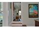 Hallway leading to a living room with water views and Florida-themed art at 546 Rio Vista Ave, Daytona Beach, FL 32114