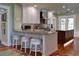 Modern kitchen with white cabinets, stainless steel appliances, and breakfast bar at 546 Rio Vista Ave, Daytona Beach, FL 32114