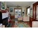 Bright living room with fireplace, natural light, and access to the outdoors at 546 Rio Vista Ave, Daytona Beach, FL 32114