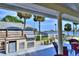 Outdoor kitchen with grill, refrigerator, and waterfront view at 546 Rio Vista Ave, Daytona Beach, FL 32114