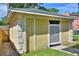 Detached shed in the backyard with lattice door and window at 546 Rio Vista Ave, Daytona Beach, FL 32114