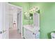 Bright bathroom with white vanity and green walls at 1333 Asher Ct # 1333, Ormond Beach, FL 32174