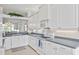 Spacious kitchen boasts white cabinets, granite countertops, and a breakfast bar at 1333 Asher Ct # 1333, Ormond Beach, FL 32174
