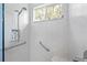 Walk-in shower with hexagonal tiles and safety features at 1333 Asher Ct # 1333, Ormond Beach, FL 32174