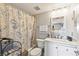 Updated bathroom with white vanity and patterned shower curtain at 2700 Ocean Shore Blvd # 508, Ormond Beach, FL 32176